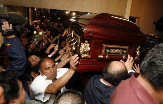 People carry the coffin containing the body of Sergio Gomez, the lead singer for the top-selling band K-Paz de la Sierra, at a funeral parlor in Mexico City,on Tuesday. Gomez, who was tortured and strangled to death, is the newest in a string of attacks that have driven fear into the heart of Mexico's music industry.