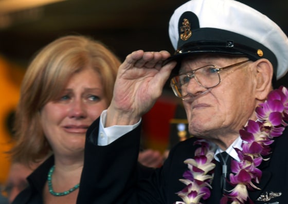 Image: Lois Deininger of San Francisco watches her father, Pearl Harbor survivor, Edward Gaulrapp of Freeport Illinois, salute during the commemoration marking the 66th anniversary of Pearl Harbor attack