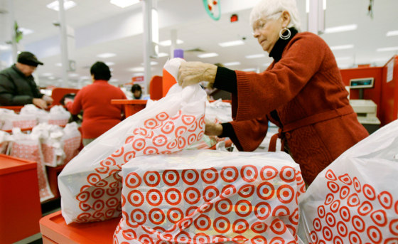 Image: A clerk bags purchases at a Target store