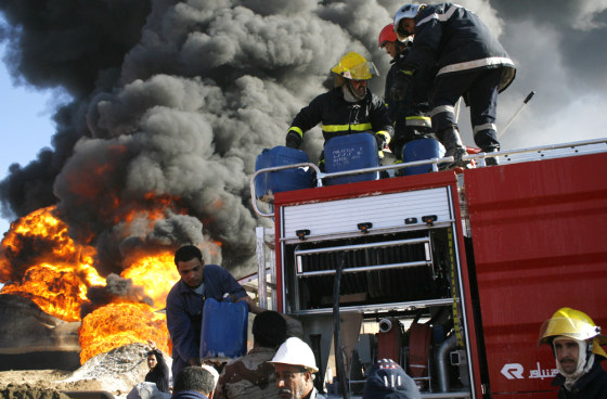 Firemen attempt to extinguish a fire at the al Dora oil refinery Monday in southern Baghdad, Iraq.