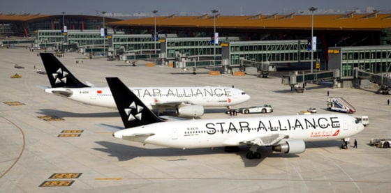 Image: To celebrate their new membership in the Star Alliance, a Shanghai Airlines Boeing 767-300 (foreground) and an Air China Airbus A330-200 painted in the alliance's colors are posed in front of the new Terminal 3 at Beijing Capital International Airp