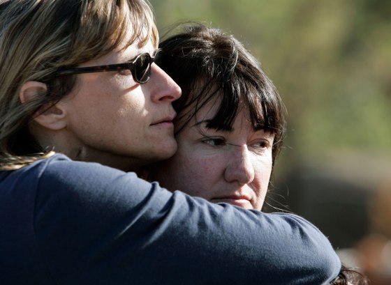 Image: Anne Gurnee, right, who lost her home in the recent wildfires, gets a hug from mentor Debbie Williams