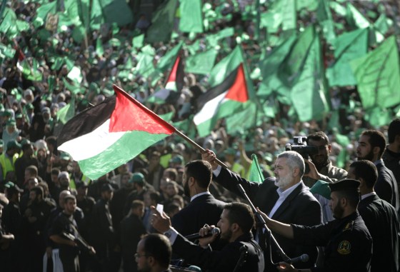 Image: Palestinian Prime Minister of the Hamas, Ismail Haniyeh, waves a Palestinian flag