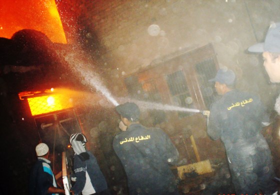 Image: Egyptian firemen attend a fire set by angry Muslim attackers at shops owned by Coptic Christians