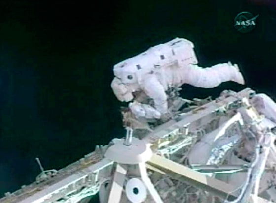 Image Commander Whitson inspects the joints on International Space Station's solar array system