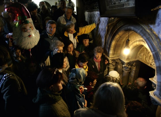 Christian pilgrims wait Monday to enter the Grotto at the Church of the Nativity, traditionally believed by many to be the birthplace of Jesus Christ, in the biblical West Bank town of Bethlehem.