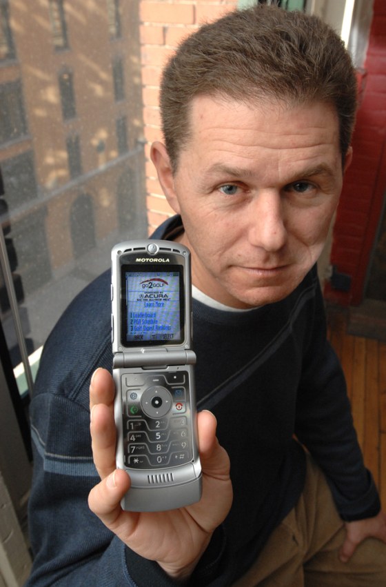 Image: Rob Adler, CEO of go2 Media holds a cell phone displaying an example of the company's efforts to deliver advertising and content targeted to the interest and location of the user