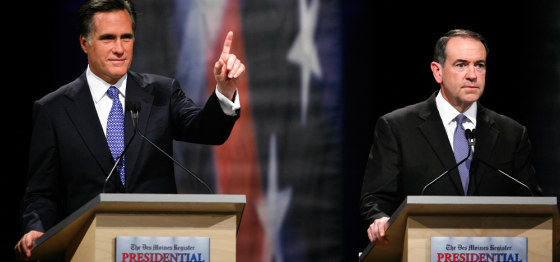 Image: Republican presidential hopefuls former Massachusetts Gov. Mitt Romney and former Arkansas Gov. Mike Huckabee during the Des Moines Register Republican Presidential Debate