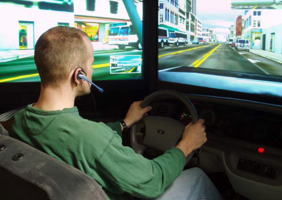 A student talks on a hands-free cell phone while operating a high-tech driving simulator during a University of Utah study in 2008. In addition to driving like impaired drunken drivers with blood-alcohol levels at the legal limit of 0.08 percent, the study showed chatty motorists bog down traffic.