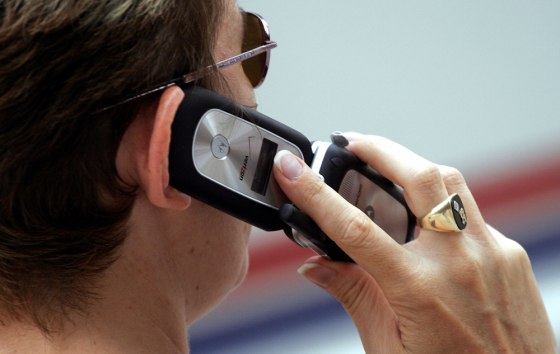 Image: A woman talks on her Verizon cell phone