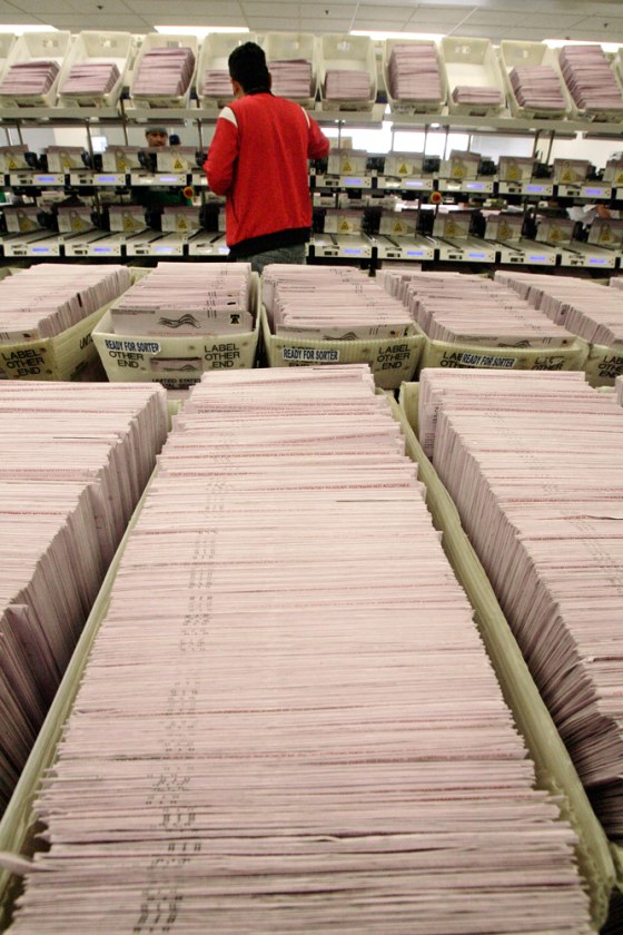 Image: Hugo Aguirre sorts ballots