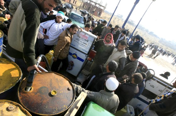 Image: Palestinians from Gaza fill their petrol canisters with gasoline in Rafah, Egypt.