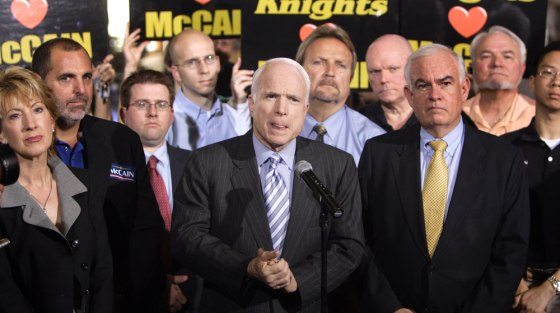 Image: John McCain bites his tongue as he answers reporters' questions