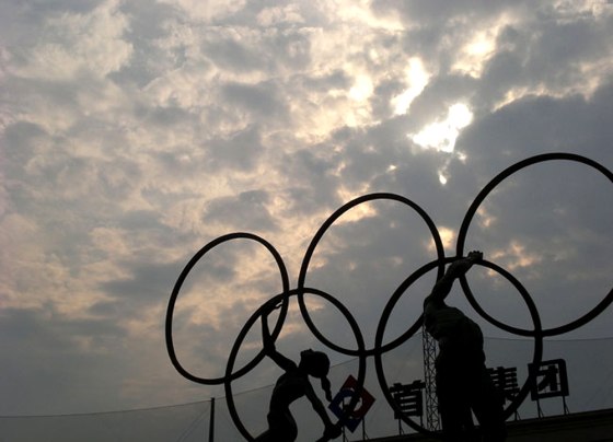 Workers prepare the huge symbolic rings that will adorn the main stadium for the 2008 Olympic Games in Beijing. The official logo of the Olympic Games has long been five interlinked rings, which symbolize the coming together of the Americas, Asia, Europe, Africa and Oceania. China appears to have prepared its commercial aviation system well for the huge influx of air travelers expected to visit Beijing and other Chinese cities for the 2008 Games. 