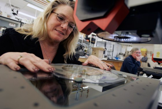 Image: Julie Cummings inspects silicon wafers holding print heads at Kodak