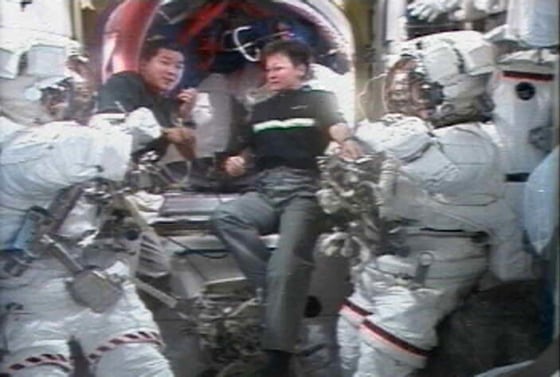 Expedition 16 flight engineer Dan Tani (left) and commander Peggy Whitson discuss their planned Jan. 30, 2008 spacewalk to replace a broken solar array joint motor outside the International Space Station.