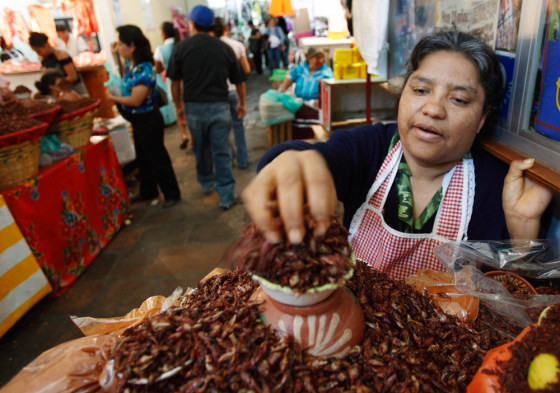 Image: Peta Ruiz sells a local delicacy of grasshoppers bathed in chile powder and salt in the city market in Oaxaca, Mexico.