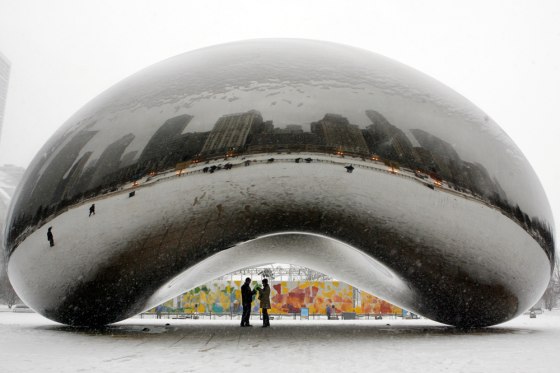 Image: Snow falls at Millennium Park in Chicago.