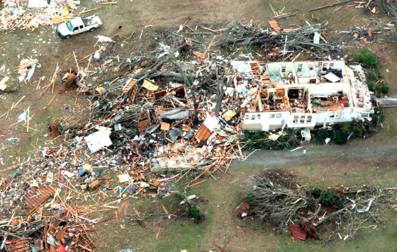 Image: Debris is scattered around a home near Clinton, Arkansas.