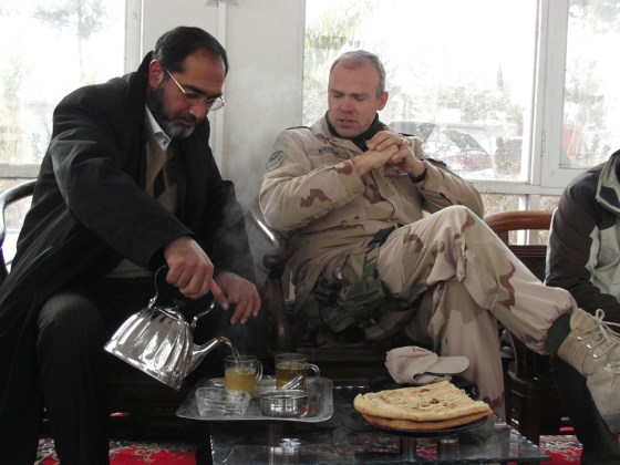 Image: Uruzgan Gov. Assadullah Hamdam pours tea for Dutch reconstruction team cheif, Lt. Col. Wilfred Rietdijk.