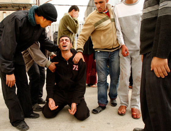 Image: A Palestinian man reacts after learning that his brother was killed by Israeli forces.