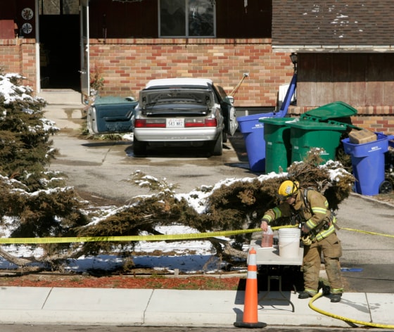 A fireman works outside a home Sunday, in Riverton, Utah, that was searched as part of the ricin investigation.