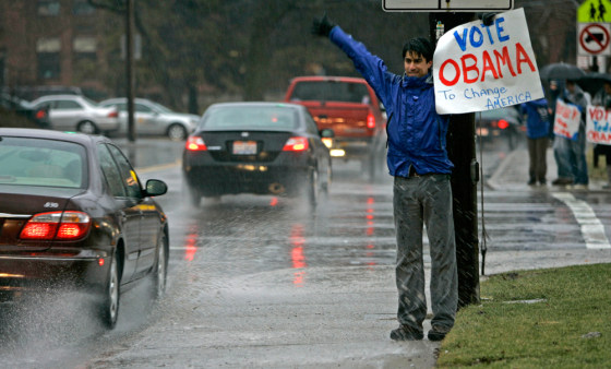 Image: An Obama supporter urges voters to the polls.