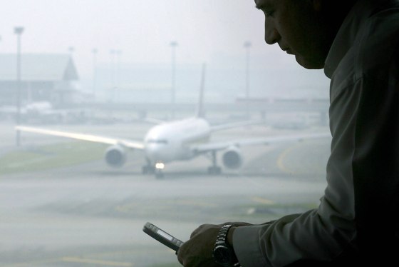 Image: A man reads a text message on his mobile