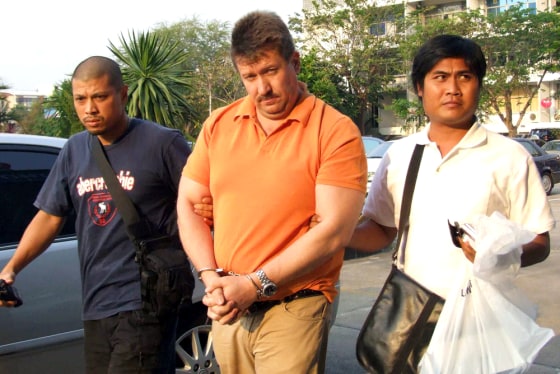 Thai police escort Russian suspected arms dealer Viktor Bout following his arrest in Bangkok on Thursday.