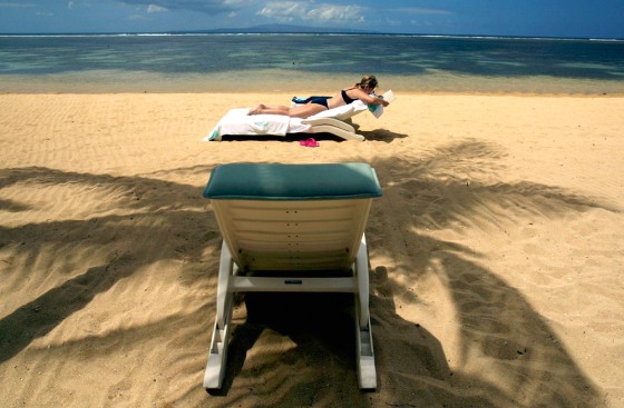 Image: A tourist sunbathes in Bali