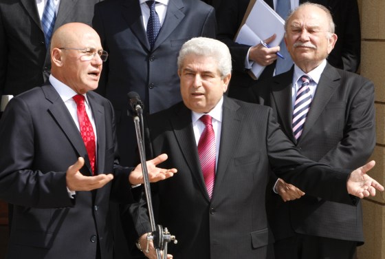 Greek Cypriot Leader Dimitris Christofias speaks with Turkish Cypriot Leader Mehmet Ali Talat at the end of their first meeting in Nicosia