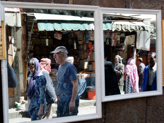 Image: Tourists are reflected on a mirror