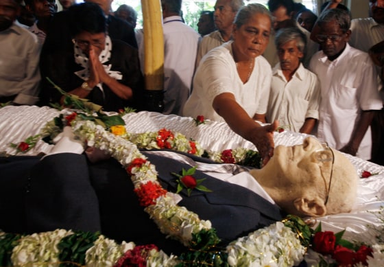 Image: People pay their last respects at the coffin of science fiction writer Clarke at his residence in Colombo