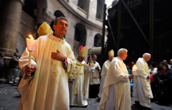 Image: Catholic clergy in a procession at the Church of the Holy Sepulchre in Jerusalem