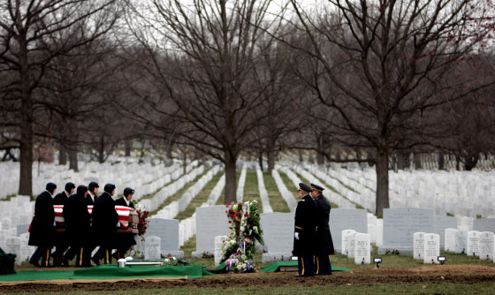 Image: A casket team carries a coffin containing the remains of US Army Corporal Christopher John-Lee West.