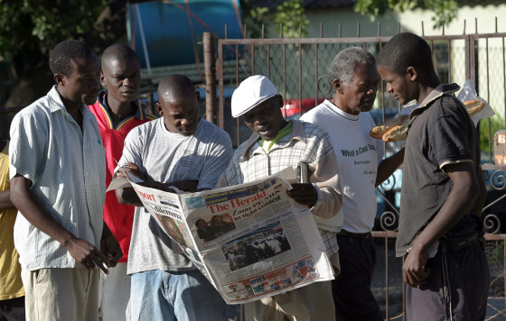 Image: Zimbabweans look for election results .
