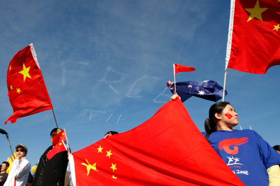 Image: Protesters wave flags