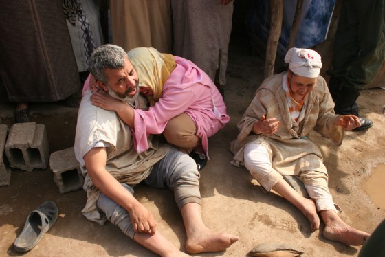 Image: Victims' relatives cry on the site of a fire that broke out in a mattress factory in Casablanca, Morocco