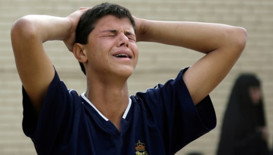 Image: An Iraqi boy weeps for his brother