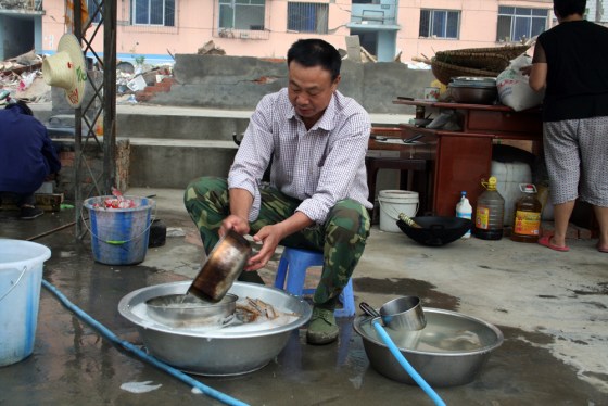 Wang Jinmu, a retired factory worker, came to hard-hit Qingchuan to volunteer for relief efforts and became the de facto chef for the government staff.