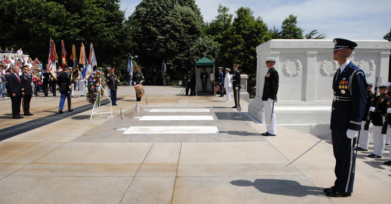 Image: Bush stands after placing wreath at the Tomb of the Unknowns
