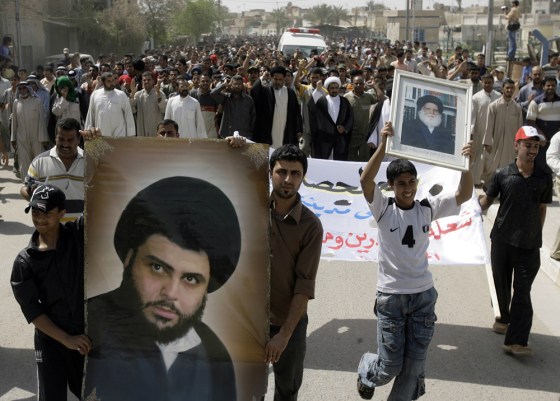 image: Iraqis display banners of Shiite radical cleric Moqtada al-Sadr