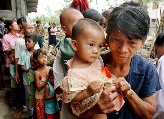 Homeless Burmese receive candy from an overseas donor at a monastery serving as a temporary shelter for cyclone victims on the outskirts of Yangon, Myanmar, earlier this week, one of many shelters reportedly being cleared.