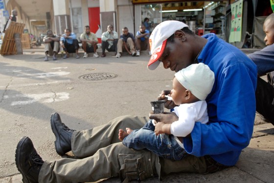 Image: An African immigrant displaced by violence outside a church in Durban, South Africa