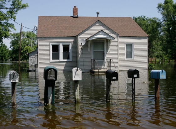 Mailboxes rise above the Mississippi floodwaters Saturday in Foley, Mo., a town that saw half of its homes swamped.