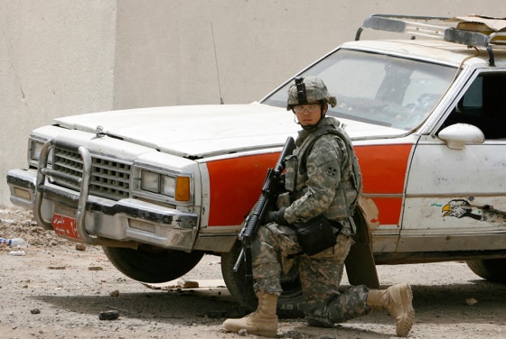 Image: U.S. soldier near car in Baghdad