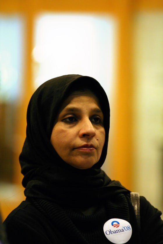Image: A Muslim woman loooks on as Sen. Barack Obama campaigns