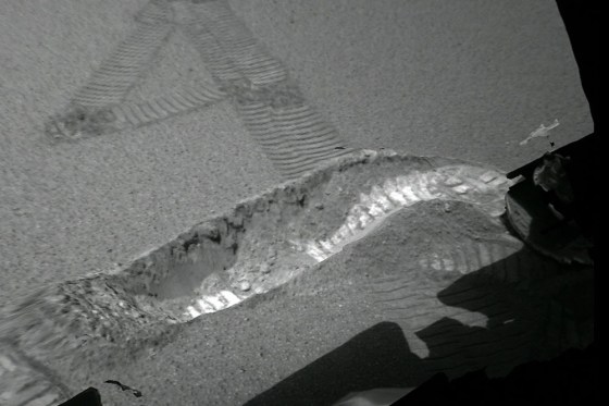 A photo taken by the Opportunity rover's camera system shows the 4-inch-deep trench that the rover excavated by spinning one of its wheels.