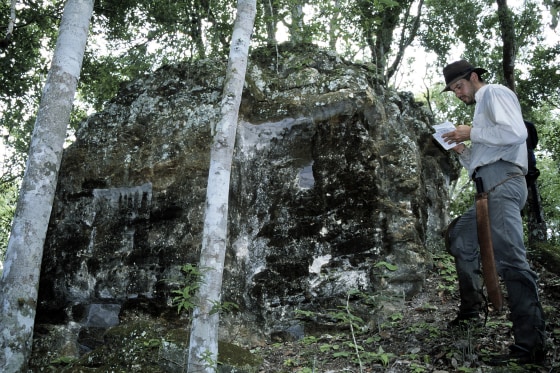 University of Calgary graduate student Marc Zender studies a Mayan ruin known as&nbsp;Structure XXIIIB during a previous expedition to Naachtun.