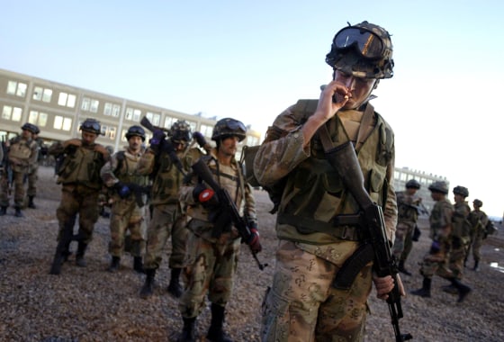A Kurdish soldier in the new Iraqi army smokes his cigarette while in ranks before morning training in Balad Ruz, Iraq, on Friday.
